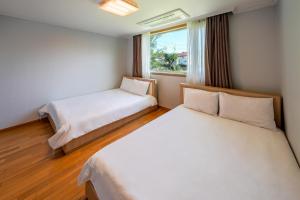 Postel nebo postele na pokoji v ubytování Harmony Resort
