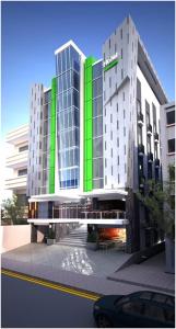 a large building with a green stripe on it at BIZ HOTEL City Center in Ambon