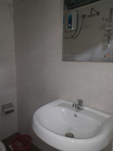 a white sink in a bathroom with a mirror at City View Hostel in Kandy