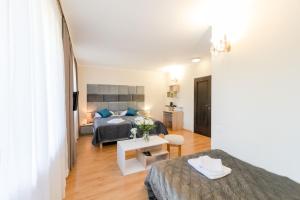 um quarto com uma cama e uma sala de estar em Rezydencja Czantoria & Spa em Ustroń