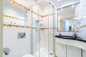 a bathroom with a shower and a sink at Rezydencja Czantoria & Spa in Ustroń