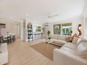 a living room with a white couch and a table at Maroochy Magic Family Coastal Getaway in Maroochydore