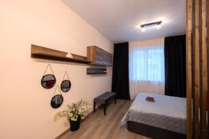 a hotel room with a bed and a window at The Red Point in Varna City