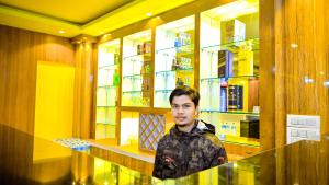 a man standing in front of a room with shelves at HOTEL STAR HOLIDAY PVT LTD in Bhairāhawā