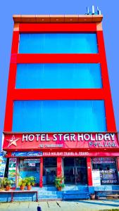 HOTEL STAR HOLIDAY PVT LTD في بهيراهاوا: مبنى احمر وزرق عليه لافته