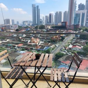 a table and chairs on a balcony with a view of a city at KSL City Mall D'esplanade By Summer in Johor Bahru