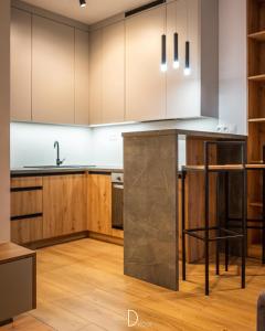 a kitchen with wooden cabinets and a counter top at One bedroom apartment in Dolný Kubín