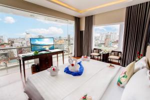 a hotel room with a bed and a large window at Thanh Lich Hue Hotel in Hue