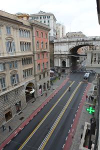 an empty street in a city with a bridge at Olympia Hotel in Genoa