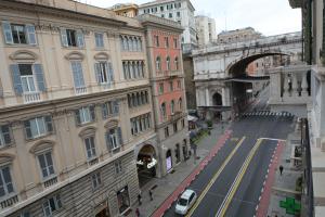 a view of a city street with buildings and a bridge at Olympia Hotel in Genoa
