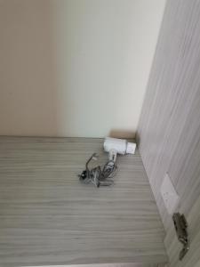 a room with a white appliance on the floor at Peaceful 1-bedroom unit at Marina Island by JoMy Homestay in Lumut