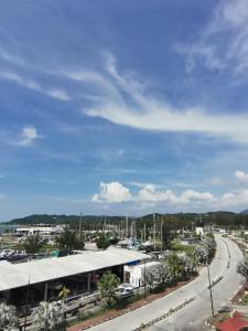 arial view of a city with a building and a road at Peaceful 1-bedroom unit at Marina Island by JoMy Homestay in Lumut