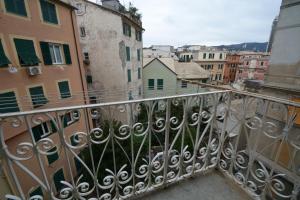 a balcony with a view of a city at Olympia Hotel in Genoa