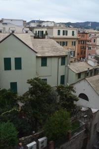 a view of a city with buildings and trees at Olympia Hotel in Genoa