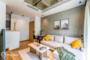 Stayhere Casablanca - Gauthier 1 - Modern Residence في الدار البيضاء: غرفة معيشة مع أريكة بيضاء وطاولة