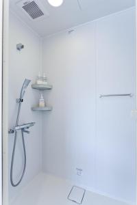 a shower in a bathroom with a glass door at CASA Kamakura Espresso&BED in Kamakura +23 photos