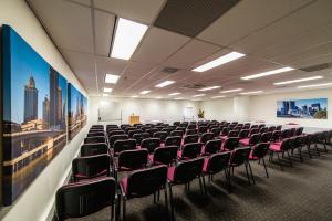 an empty room with chairs in a building at George Williams Hotel in Brisbane