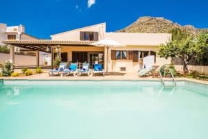 a swimming pool in front of a house at Ideal Property Mallorca - Ca na Tonina in Port de Pollensa