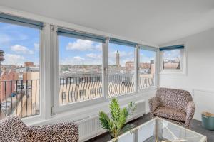 a room with a balcony with a view of a city at Boardman Lodge, City centre, Park view, Games - Ginger & Gold ltd in Norwich