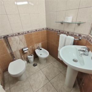 a bathroom with a toilet and a sink at Sunny Studio In Santa Maria Aparthotel in Adeje