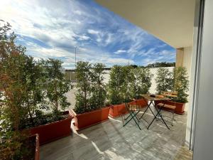 a balcony with plants and a table and chairs at Bari Airport Rooms in Bari