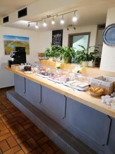 a buffet line in a restaurant with food at Pension Grübel in Lindau