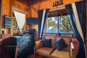 a living room with a bench and a window at The Bali House and Cottage at Kehena Beach Hawaii in Kehena