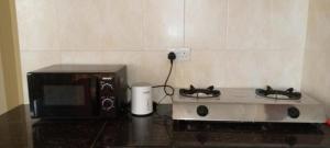 a kitchen with a microwave and a toaster oven at Alpha Homes in Kilifi