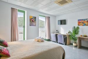 a bedroom with a large bed and a table and chairs at Les Begues Apartments in Begues