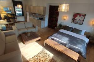 a living room with a large bed and a couch at Lumen 1-bedroom apartment in the heart of Trikala in Tríkala