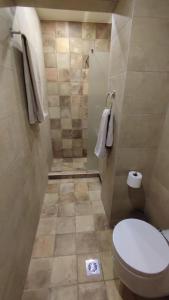 a small bathroom with a toilet and a tiled floor at Lumen 1-bedroom apartment in the heart of Trikala in Tríkala