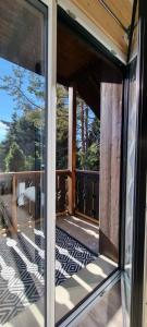 a room with sliding glass doors on a balcony at Mont Bivouac, chambre,entrée et Sdb privée,balcon vue MtBlanc in Passy