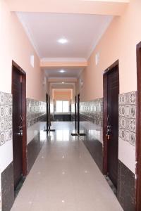 a hallway of a building with doors and tile floors at HOTEL DREAM PALACE in Puri