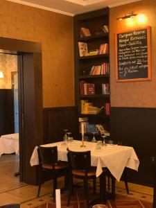 a dining room with a table with chairs and a chalkboard at Landmark am Kracauerplatz in Berlin