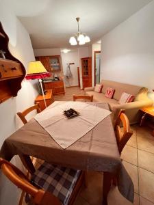 een woonkamer met een tafel en een bank bij Stella Alpina in Tarvisio