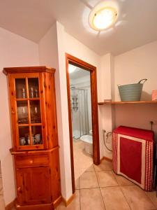 a bathroom with a wooden cabinet and a mirror at Stella Alpina in Tarvisio