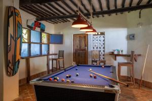 a room with a pool table with balls on it at Blue Marlin Beach Hotel in Diani Beach