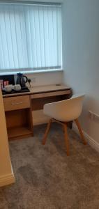 a desk and a chair in a room with a window at No. 5 in Hartlepool