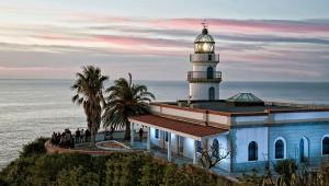 a lighthouse on top of a building next to the ocean at CALELLA DE LA COSTA ( Maresme - Costa Brava) in Calella