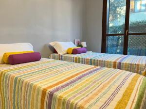 two beds sitting next to each other in a room at Bnbook-Casa Andrea in Cardano al Campo