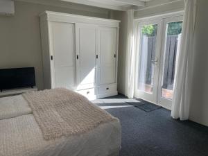 a bedroom with a bed and a large window at Bella Gelria in Wezep