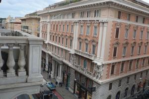 a view of a city street with buildings at Olympia Hotel in Genoa