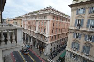 a building on a city street with a bus at Olympia Hotel in Genoa