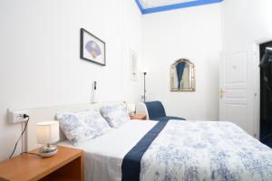 a bedroom with a bed and a table and a chair at Olympia Hotel in Genoa