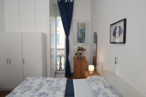 a bedroom with two beds and a window at Olympia Hotel in Genoa