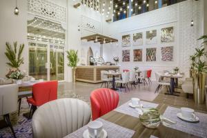 a restaurant with tables and chairs in a room at Central Inn Souq Waqif in Doha