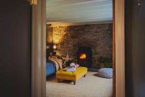 a bedroom with a bed and a stone wall at River Cottage, a luxurious and cosy riverside cottage for two in Welshpool