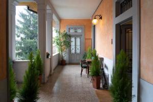 a hallway of a home with a table and plants at Varese Suites in Varese