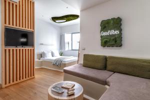 a living room with a couch and a table at LOFUS Bio-Suites in Athens