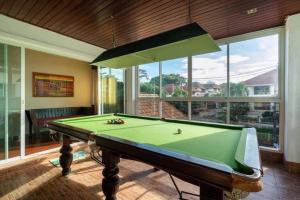 a pool table in a room with a large window at Angel Pool Villa Phuket - SHA Exta Plus in Phuket